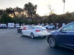 Teslas Lined Up Waiting To Charge
